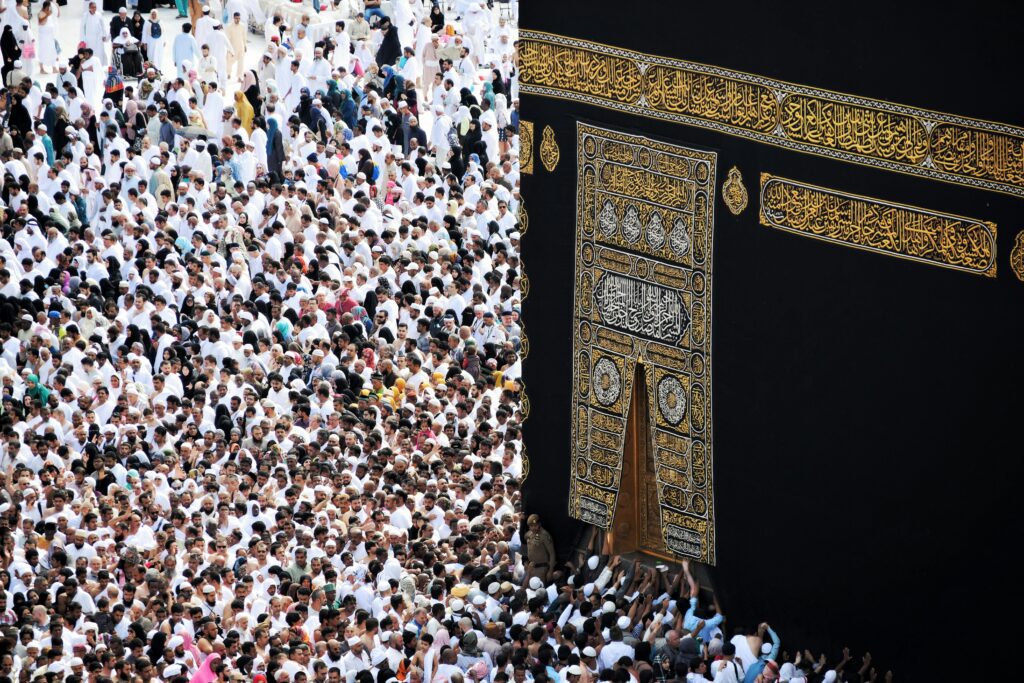 Mass of pilgrims in traditional attire at Kaaba during the Hajj pilgrimage.